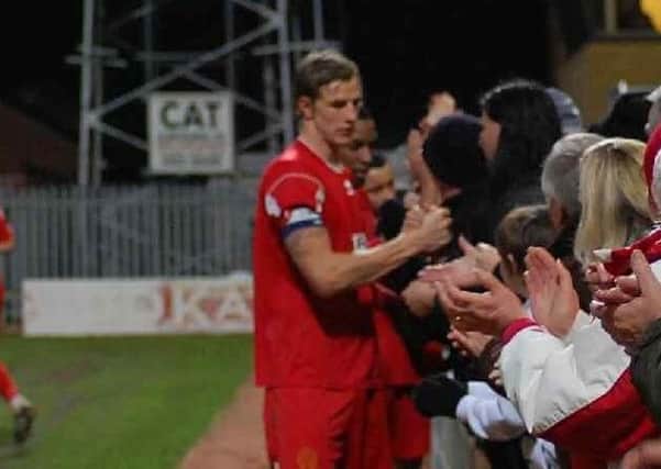 CELEBRATION TIME: Alfreton Town captain Aden Flint celebrates with fans at the end of the Reds' 6-3 extra time FA Trophy second round replay victory at Cambridge United