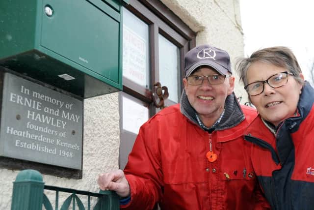 Jackie and David Teideman pictured at Heatherdene Kennels which is celebrating it's 70th anniversary, pay tribute to it's founders Ernie and May Hawley by way of a plaque on their reception doorway.