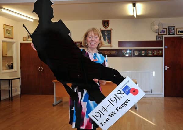 Vivien Miller, the Poppy Appeal organiser for the Chesterfield branch of the RBL with the silent soldier.