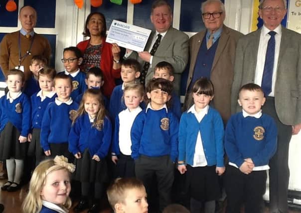 Martin Thacker,chairman of the Chesterfield General Charitable Trust Fund, presents a cheque for Â£3,500 to New Whittington Primary School, Chesterfield.