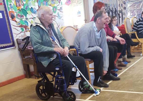 Care home residents at curling match in Holmewood Community Centre.