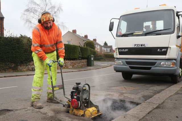 Council workers get to grips with another pothole.