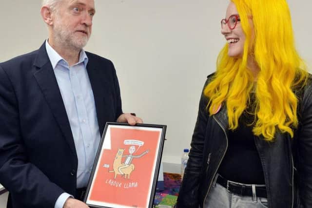 Mr Corbyn with Katie Abey who presented a cartoon drawing to him.