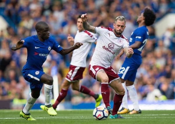 Steven Defour takes the ball away from Chelsea's N'Golo Kante