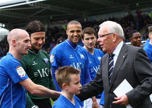 Retiring Chairman Barrie Hubbard shakes the hands of the Chesterfield captain Drew Talbot at his last match in charge