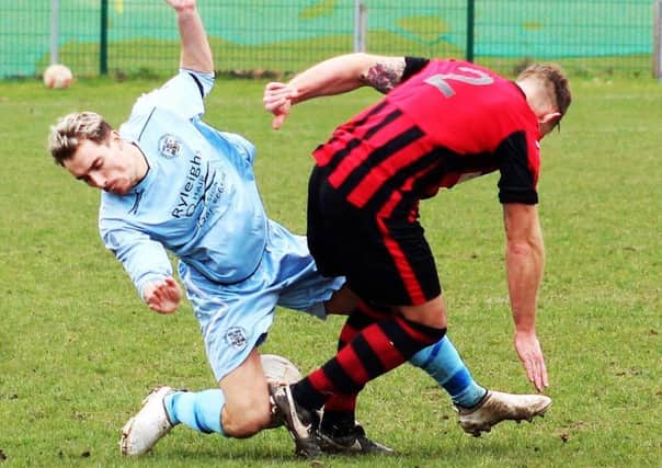 Josh Holland, of Clay Cross, tries to get past Dronfields Jon McLoughlin. (PHOTO BY: David Clark)