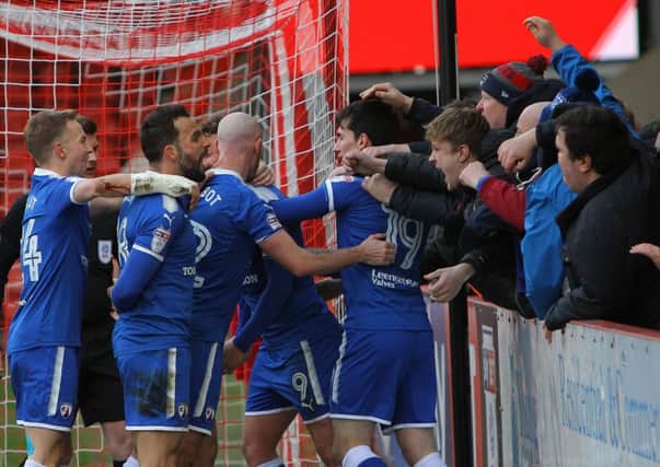 Picture by Sam Mallorie-Williams/AHPIX.com; Football; Sky Bet League Two; Cheltenham Town v Chesterfield FC; 17/03/2018 KO 15.00; LCI Rail Stadium; copyright picture; Howard Roe/AHPIX.com; Chesterfield fans join in the celebrations as Kristian Dennis is mobbed by his team mates after scoring the opener at Cheltenham