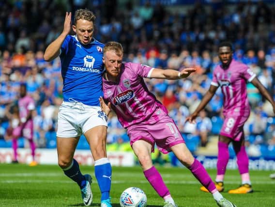 Kristian Dennis (left) in action when Chesterfield faced Grimsby on the opening day of the season.