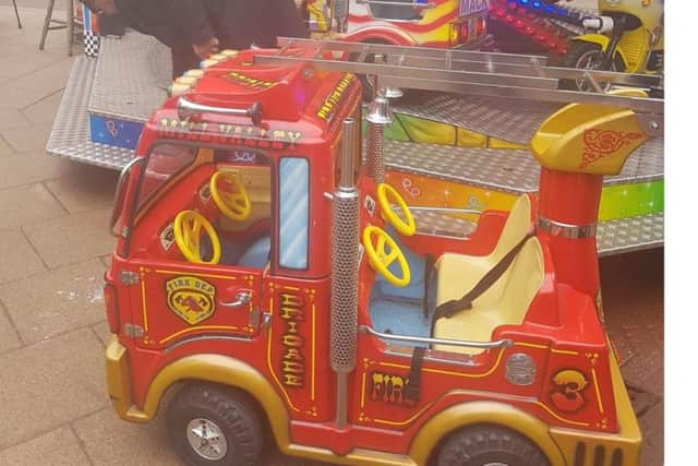 The pretend fire engine after it left the platform of the merry-go-round.