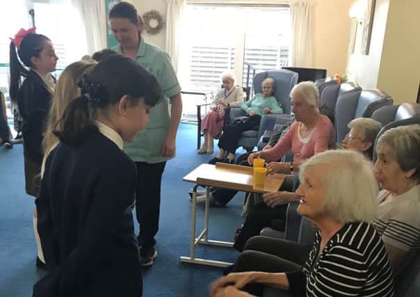 Holmewood Primary School pupils take gifts and sing to residents of Brimington Care Centre.