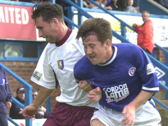 Ryan Williams (right) and Bobby Hassell tussle in the 2000 encounter.
