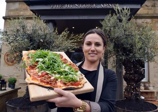 General manager Kamila Muszak shows off the food on offer at the Hunloke Arms