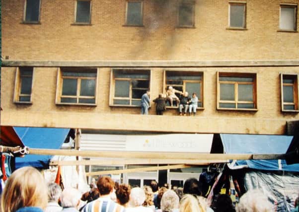 Picture shows people trying to escape the Littlewoods fire by climbing out of the windows.