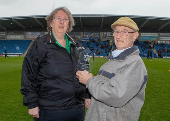 Carol Crompton receives Chesterfield FC's Award of Merit from Alec Freeman. Picture by Tina Jenner.