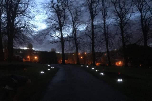 The candlelit drive of Spital Cemetery as dawn broke this morning.