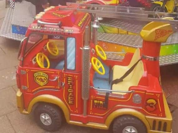 The pretend fire engine after it left the platform of the merry-go-round.