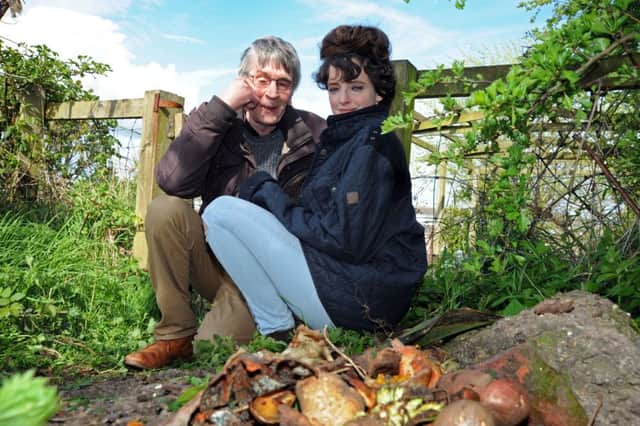 George Davison pictured with his partner Kate next to the compost heap.