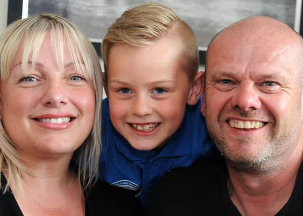 Max Allgood with his mum Claire and dad Derek.