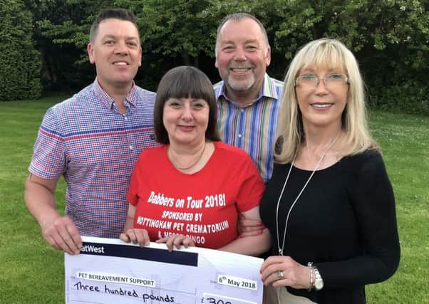 Pet Bereavement Charity fundraiser Yvette Price-Mear (red top) is pictures receiving her sponsorship funding from the Nottingham Pet Crematorium owners John & Rita Harbury-Carlisle and Manager Simon Saunders (left).  Photo by Robert Rathbone.