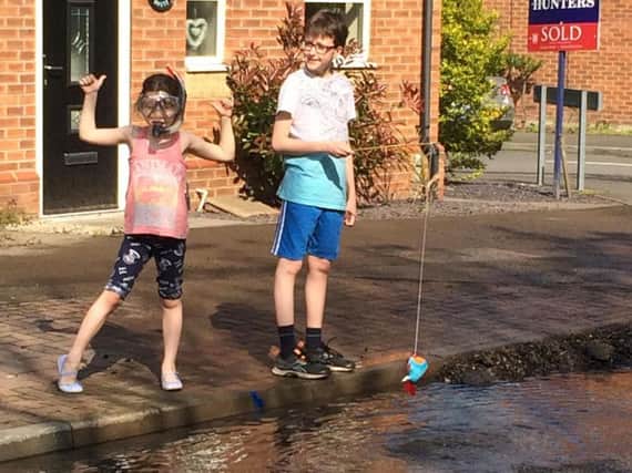 Riley and Summer Jackson make the most of a pothole in Inkersall