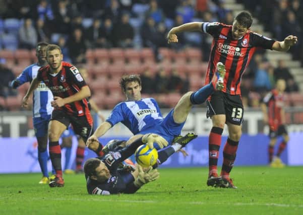 FA Cup third round football action - Wigan Athletic V AFC Bournemouth, held at DW Stadium.
Wigan's Mauro Boselli falls as Bournemouth's Tommy Elphick, right, goes to tackle and goalkeeper, Shwan Jalal, left, goes for the ball.