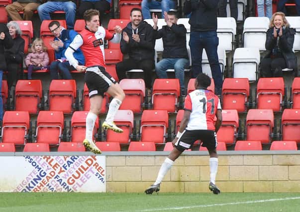 Charlie Carter celebrates a goal for Woking last season (Pic: Andy Fitzsimons)
